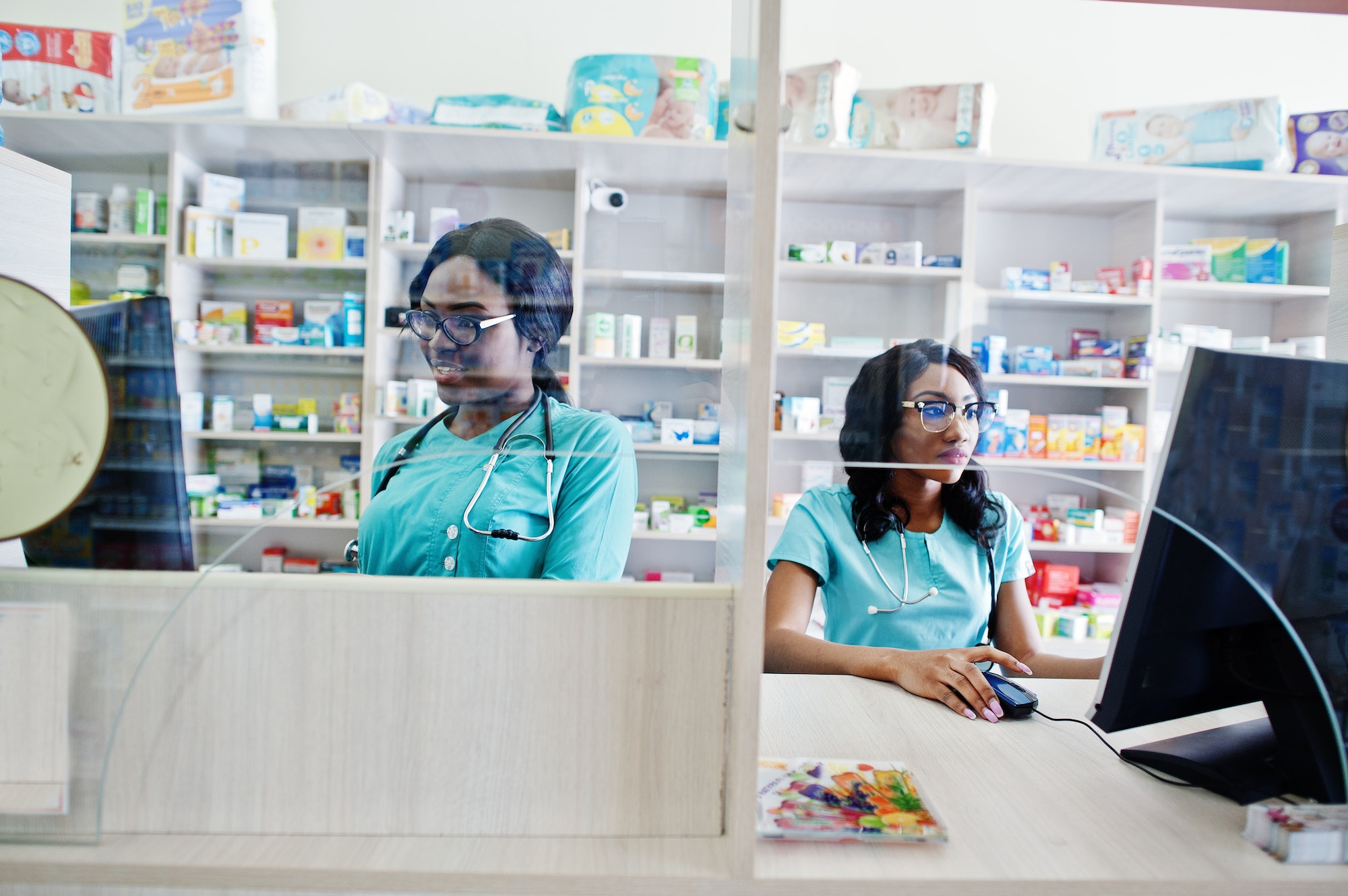 African american pharmacist working in drugstore