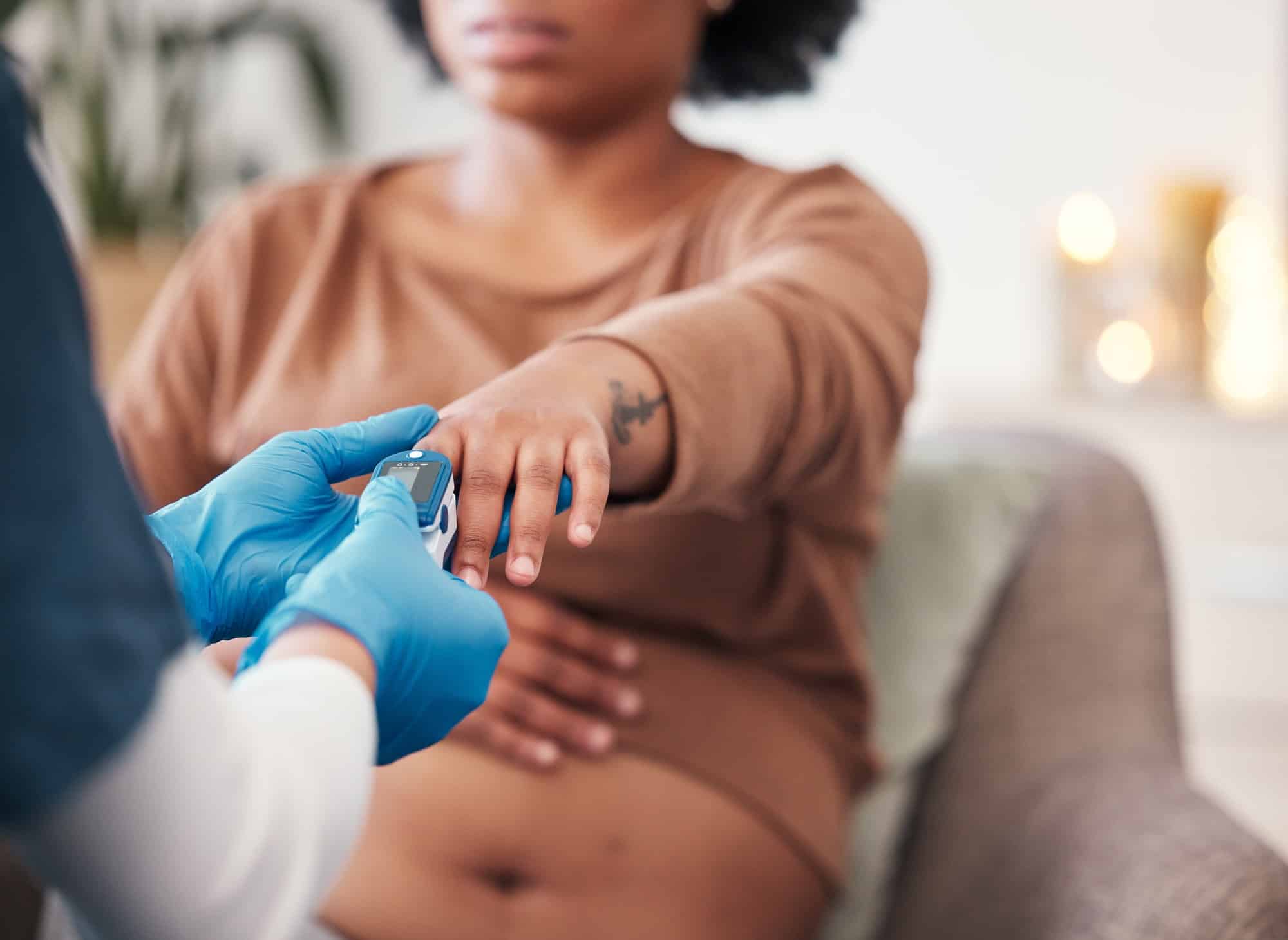 Pulse device on finger, pregnant woman and doctor checkup for blood oxygen level measurement. Medic